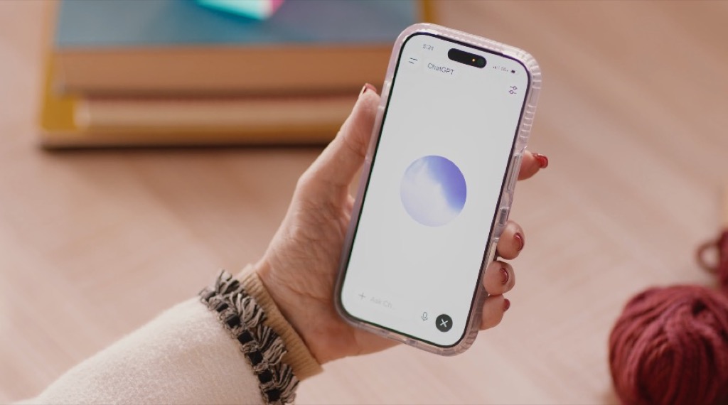 Hand holding a phone showing the ChatGPT Voice orb during a GPT-Live conversation